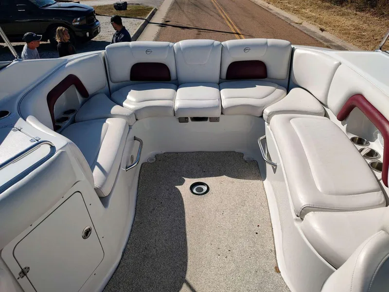 Slide: The Image of 2006 Crownline 270 BR boat interior with white and maroon seating, spacious layout. - 9