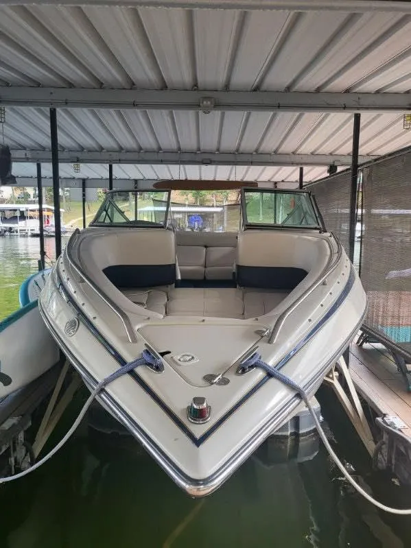 Slide: The Image of 2001 Crownline 248 BR boat docked under a covered marina. - 10