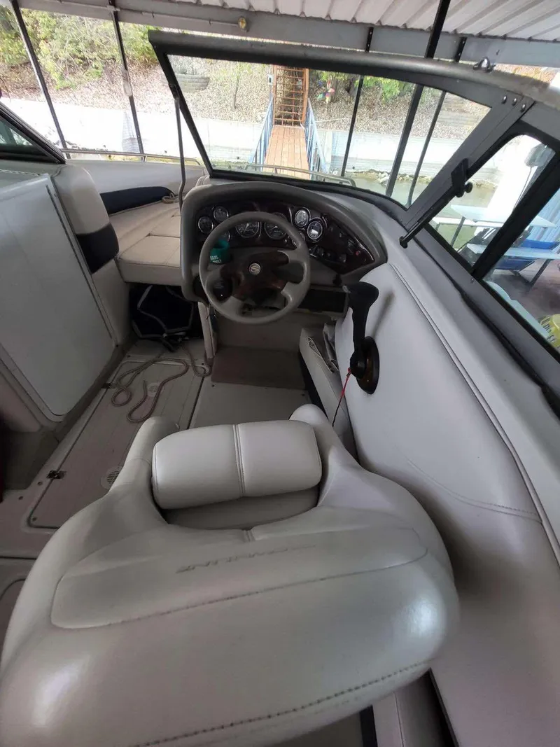 Slide: The Image of 2001 Crownline 248 BR boat interior with steering wheel and dashboard. - 11