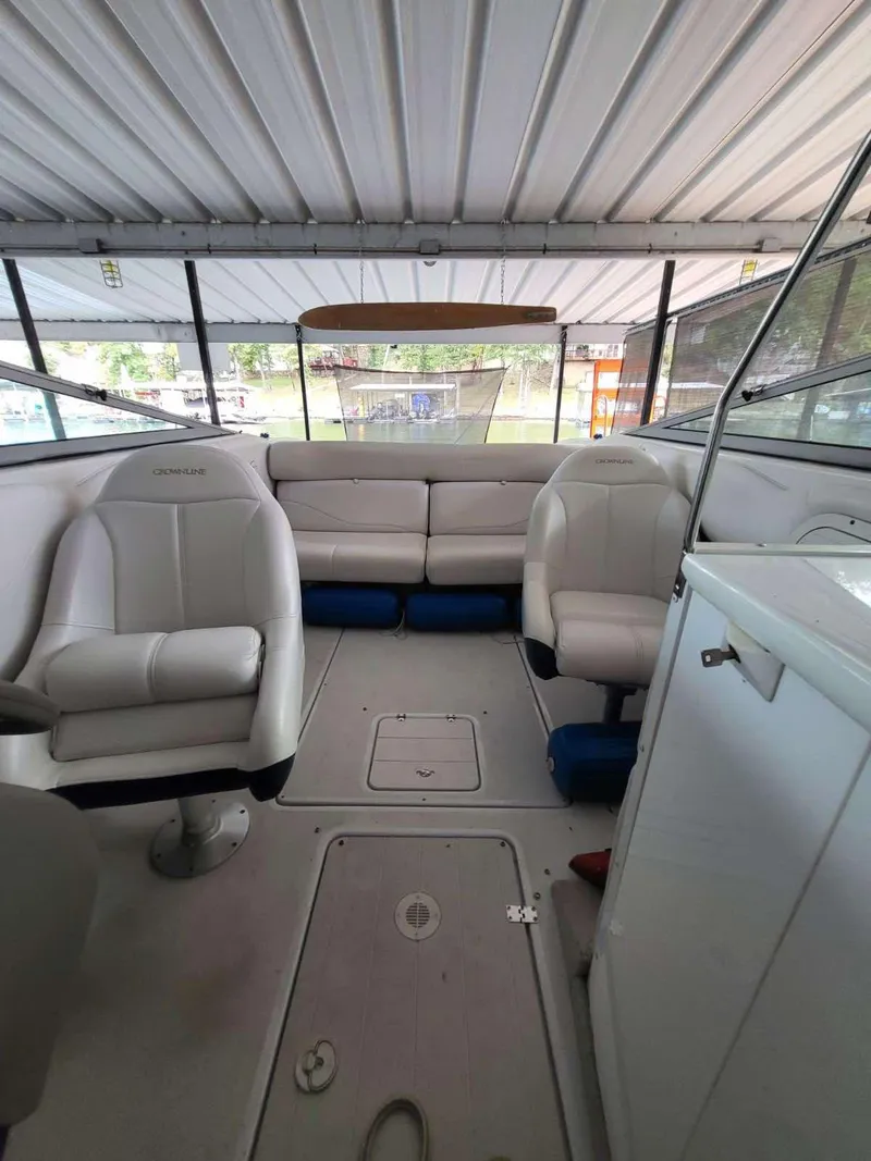 Slide: The Image of 2001 Crownline 248 BR boat interior with white seating and covered deck. - 9