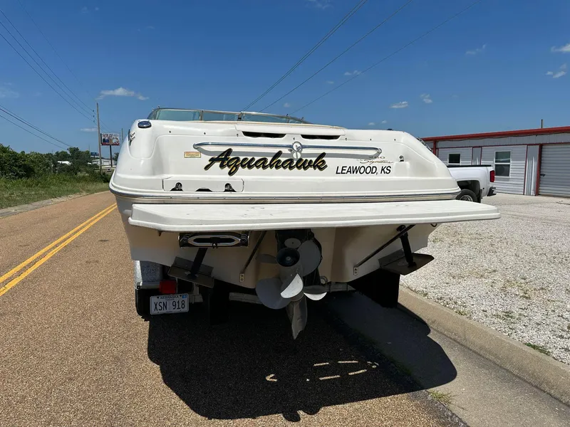 Slide: The Image of 2001 Sea Ray 260 Bow Rider boat on road, rear view, sunny day. - 5
