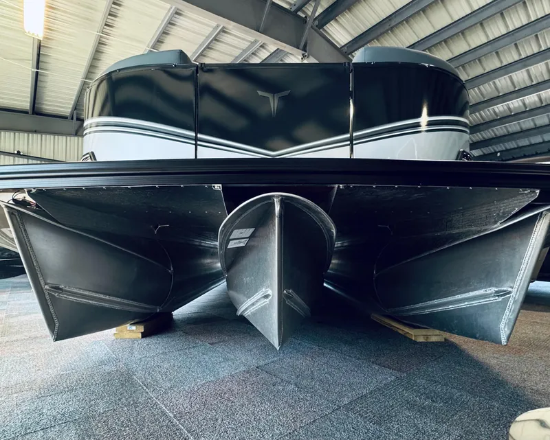 Slide: The Image of 2025 Tahoe Pontoon LTZ Versatile Rear Bench, sleek design in a showroom setting. - 17