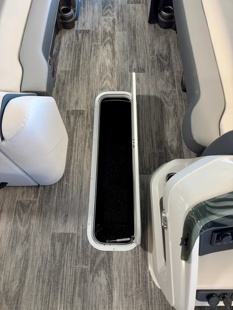 Slide: The Image of 2025 Tahoe Pontoon LTZ Versatile Rear Bench interior with open storage compartment. - 4