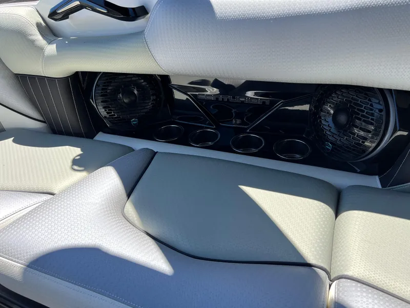 Slide: The Image of 2024 Centurion Fi23 boat interior with premium speakers and cup holders. - 10