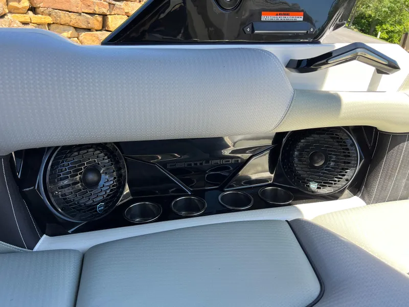 Slide: The Image of 2024 Centurion Fi23 boat interior with speakers and cup holders. - 13