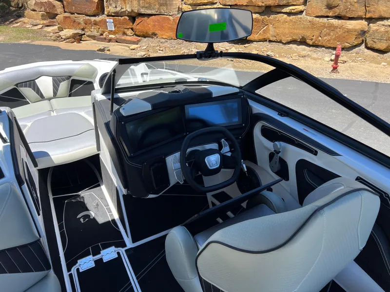 Slide: The Image of 2024 Centurion Fi23 boat interior with modern dashboard and sleek seating design. - 18