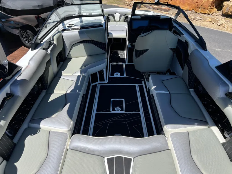 Slide: The Image of 2024 Centurion Fi23 boat interior with sleek gray seating and modern design. - 25