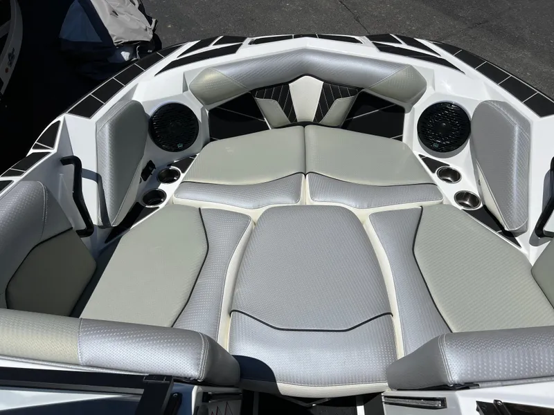 Slide: The Image of 2024 Centurion Fi23 boat interior with gray seating and built-in speakers. - 9