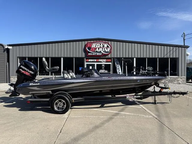Slide: The Image of 2016 Triton 189 TRX boat parked outside a marine dealership. - 1