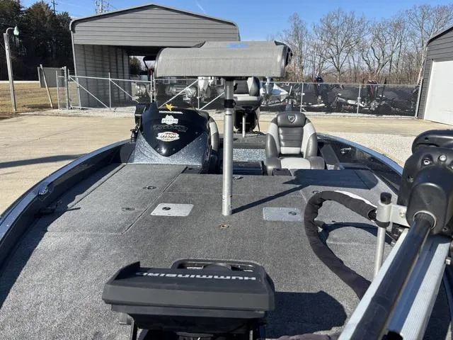 Slide: The Image of 2016 Triton 189 TRX fishing boat with trolling motor and spacious deck in a storage area. - 11