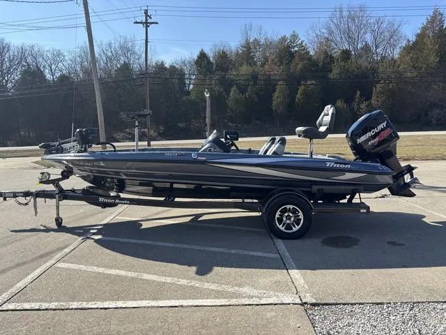 Slide: The Image of 2016 Triton 189 TRX bass boat on trailer, parked outdoors. - 14