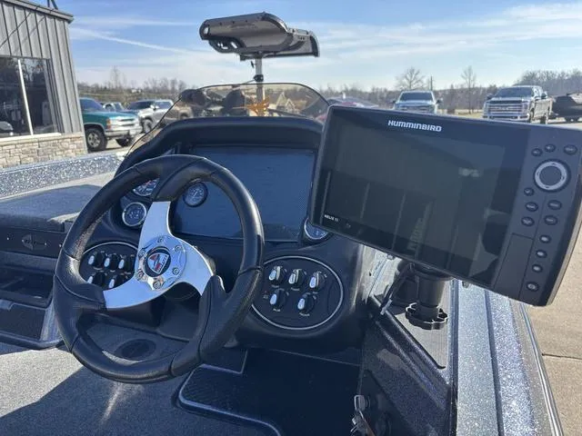 Slide: The Image of 2016 Triton 189 TRX boat dashboard with steering wheel and Humminbird fish finder. - 5