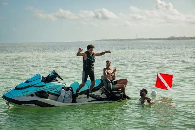 Slide: The Image of 2025 Yamaha Waverunner FX Cruiser HO with people enjoying water activities. - 17