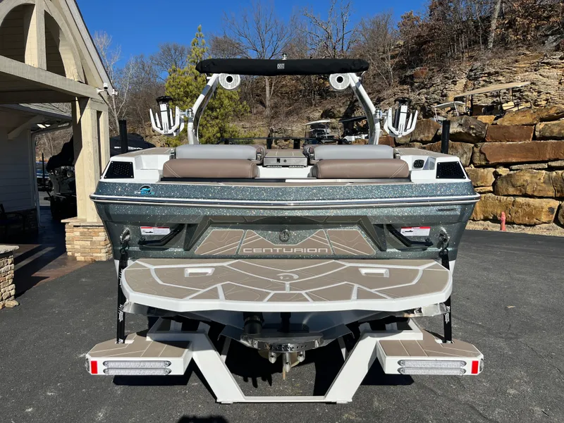 Slide: The Image of 2025 Centurion Fe25 boat, rear view, parked outdoors on a sunny day. - 10