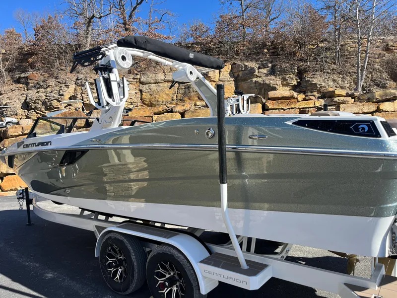 Slide: The Image of 2025 Centurion Fe25 boat on trailer, sleek design, parked outdoors. - 11