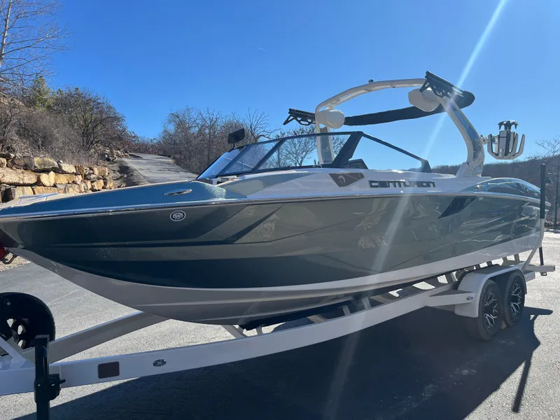 Slide: The Image of 2025 Centurion Fe25 boat on trailer, sleek design, sunny outdoor setting. - 12