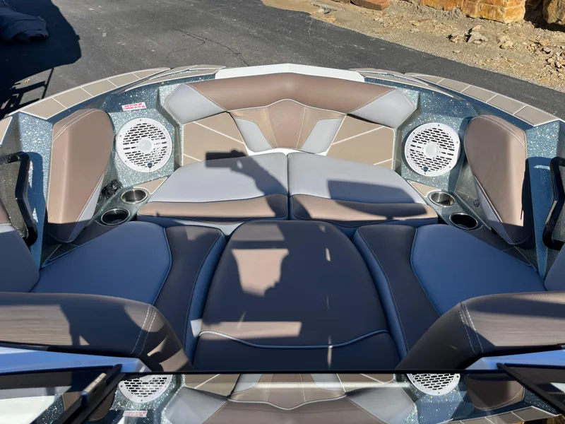 Slide: The Image of 2025 Centurion Fe25 boat interior with cushioned seating and built-in speakers. - 22