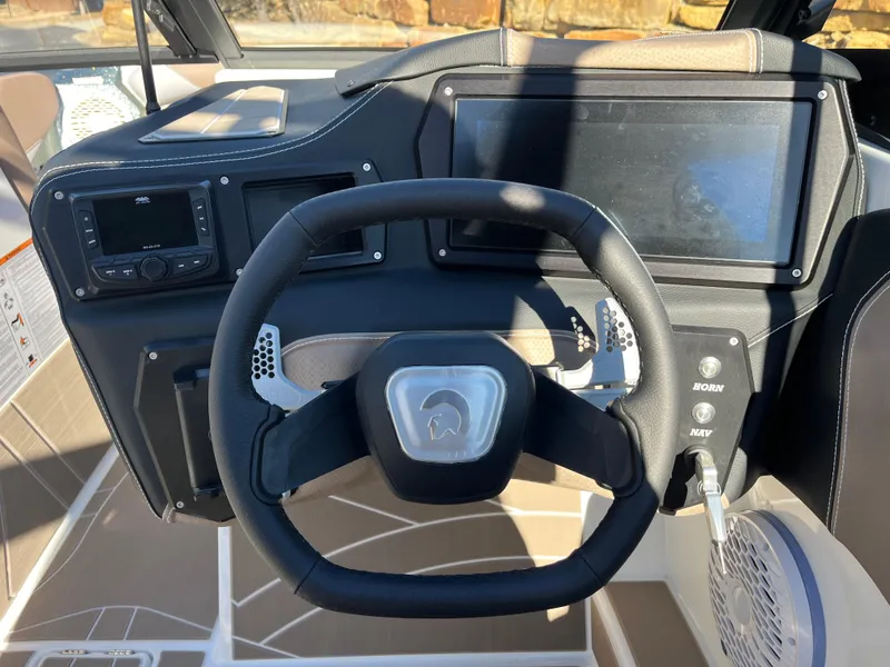 Slide: The Image of Steering wheel and dashboard of 2025 Centurion Fe25 boat, featuring modern controls and displays. - 28