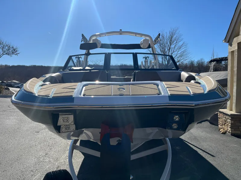 Slide: The Image of 2025 Centurion Fe25 boat on trailer under clear blue sky. - 8