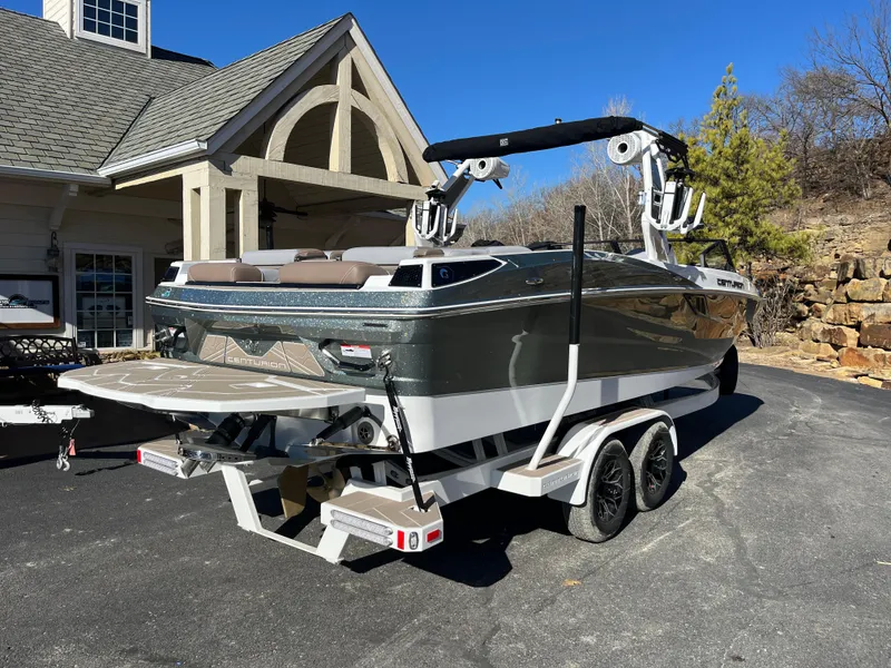 Slide: The Image of Centurion Fe25 2025 boat on trailer, parked in driveway, sunny day. - 9