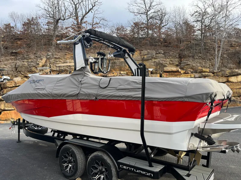 Slide: The Image of 2025 Centurion NV233 boat with cover on trailer, parked outdoors. - 16