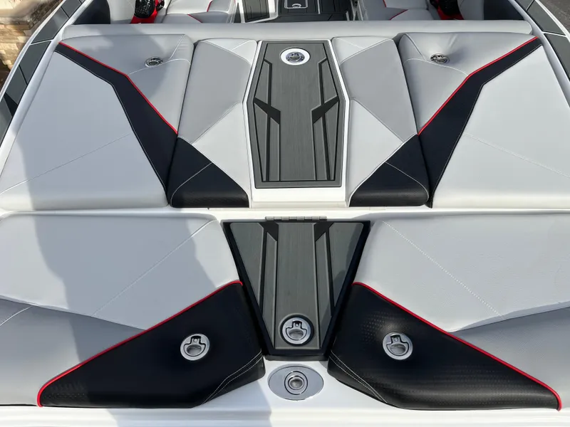 Slide: The Image of 2025 Centurion NV233 boat interior with sleek, modern upholstery design in gray, black, and red accents. - 18