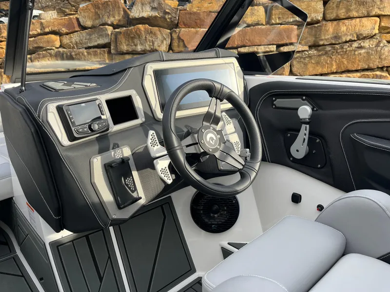 Slide: The Image of 2025 Centurion NV233 boat dashboard with modern steering and controls. - 22