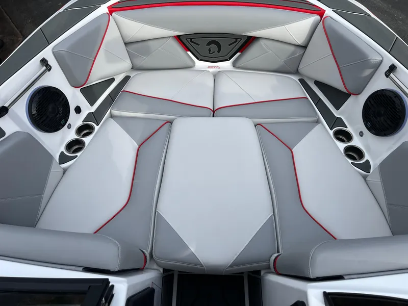 Slide: The Image of Interior of 2025 Centurion NV233 boat with sleek gray and red seating design. - 24