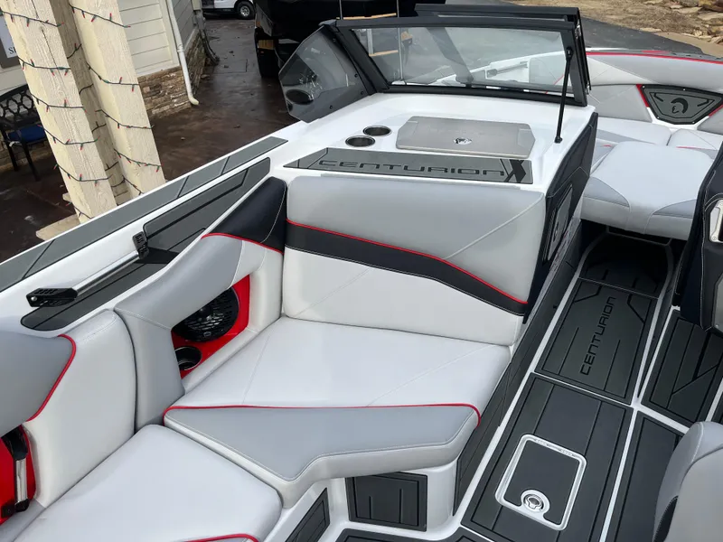 Slide: The Image of 2025 Centurion NV233 boat interior with sleek gray and red seating design. - 25