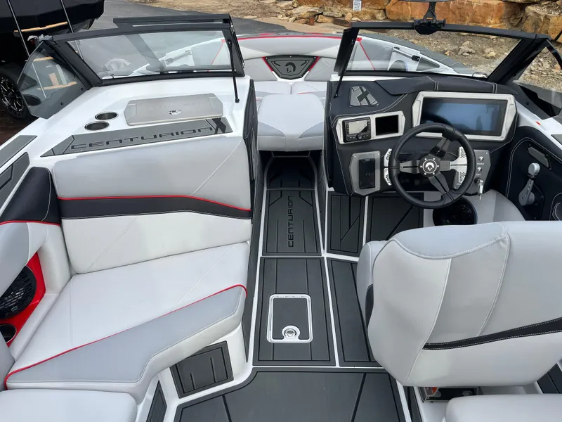 Slide: The Image of 2025 Centurion NV233 boat interior with modern dashboard, sleek seating, and advanced controls. - 26