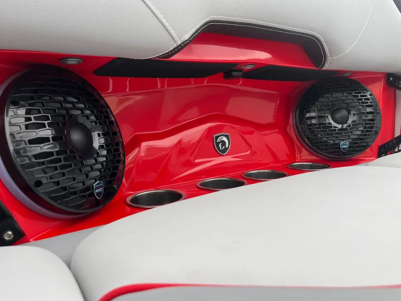 Slide: The Image of Centurion NV233 2025 boat interior with red panel and built-in speakers. - 28