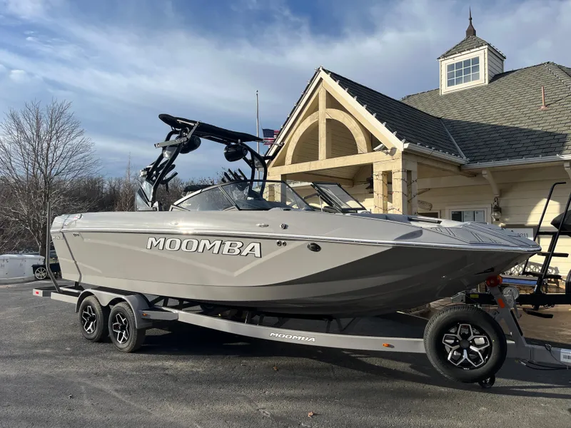 Slide: The Image of 2025 Moomba Makai boat on trailer, parked near a house with a gabled roof. - 1