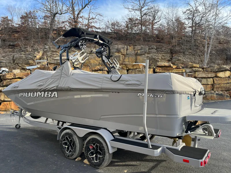 Slide: The Image of 2025 Moomba Makai boat on trailer, covered, parked outdoors. - 10