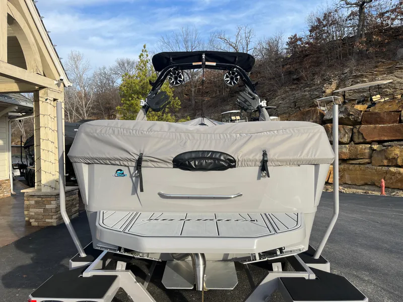 Slide: The Image of 2025 Moomba Makai boat, rear view, covered, parked outdoors. - 11