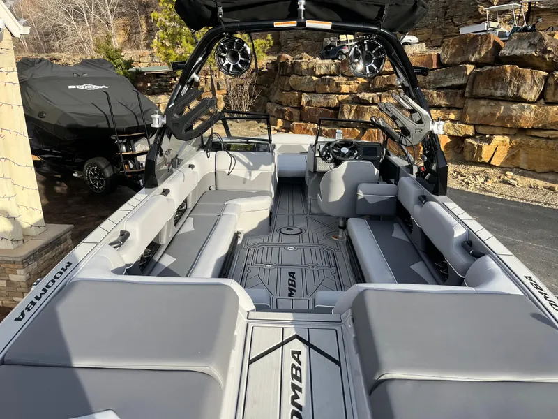 Slide: The Image of 2025 Moomba Makai boat interior with gray seating and advanced audio system. - 14