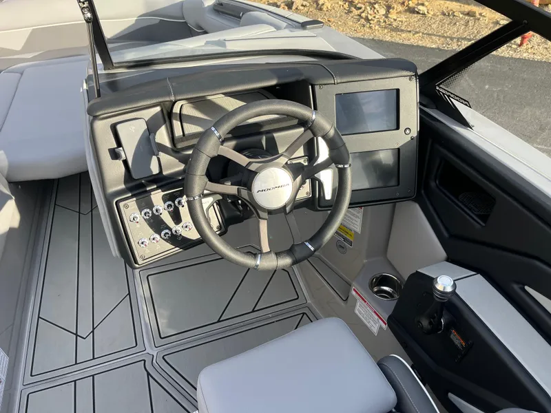 Slide: The Image of 2025 Moomba Makai boat dashboard with steering wheel and digital display. - 17