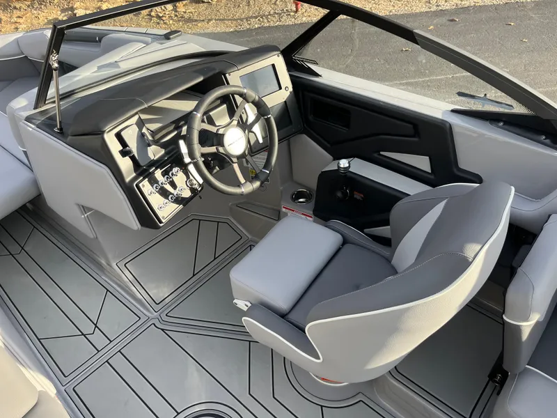 Slide: The Image of 2025 Moomba Makai boat interior with modern steering wheel and sleek dashboard design. - 18