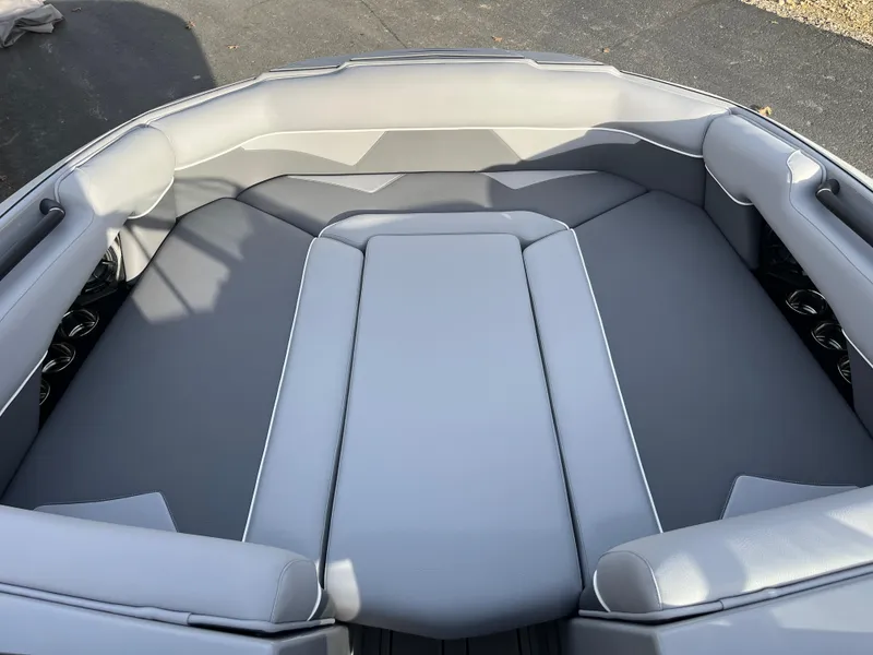 Slide: The Image of 2025 Moomba Makai boat interior with gray seating and cup holders. - 24