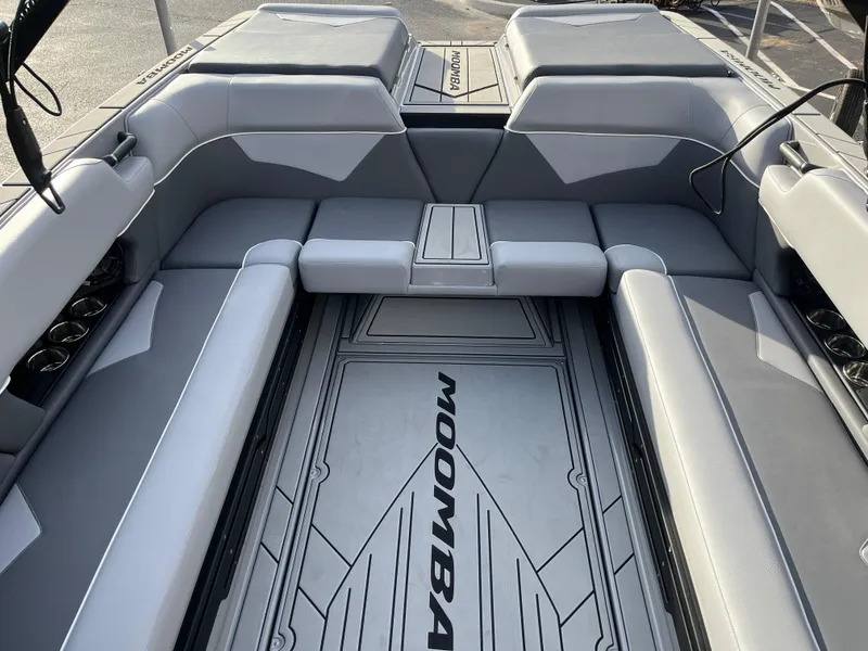 Slide: The Image of 2025 Moomba Makai boat interior with gray seating and branded flooring. - 25