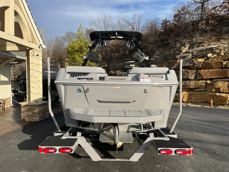 Slide: The Image of 2025 Moomba Makai boat on trailer, parked outdoors near a house and rocky landscape. - 3