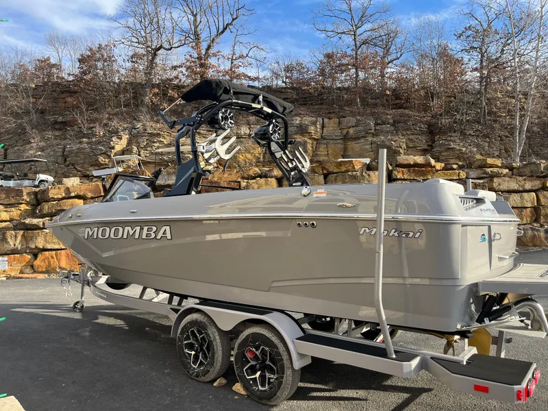 Slide: The Image of 2025 Moomba Makai boat on trailer, parked outdoors with rocky background. - 4