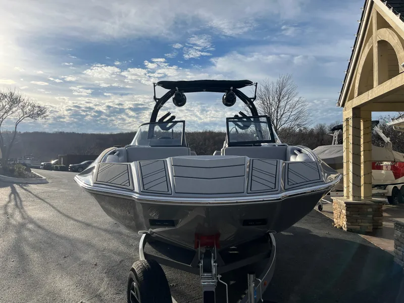 Slide: The Image of 2025 Moomba Makai boat on trailer, parked outdoors under a cloudy sky. - 6