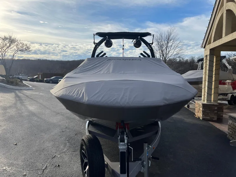 Slide: The Image of 2025 Moomba Makai boat covered on a trailer, parked outdoors. - 8