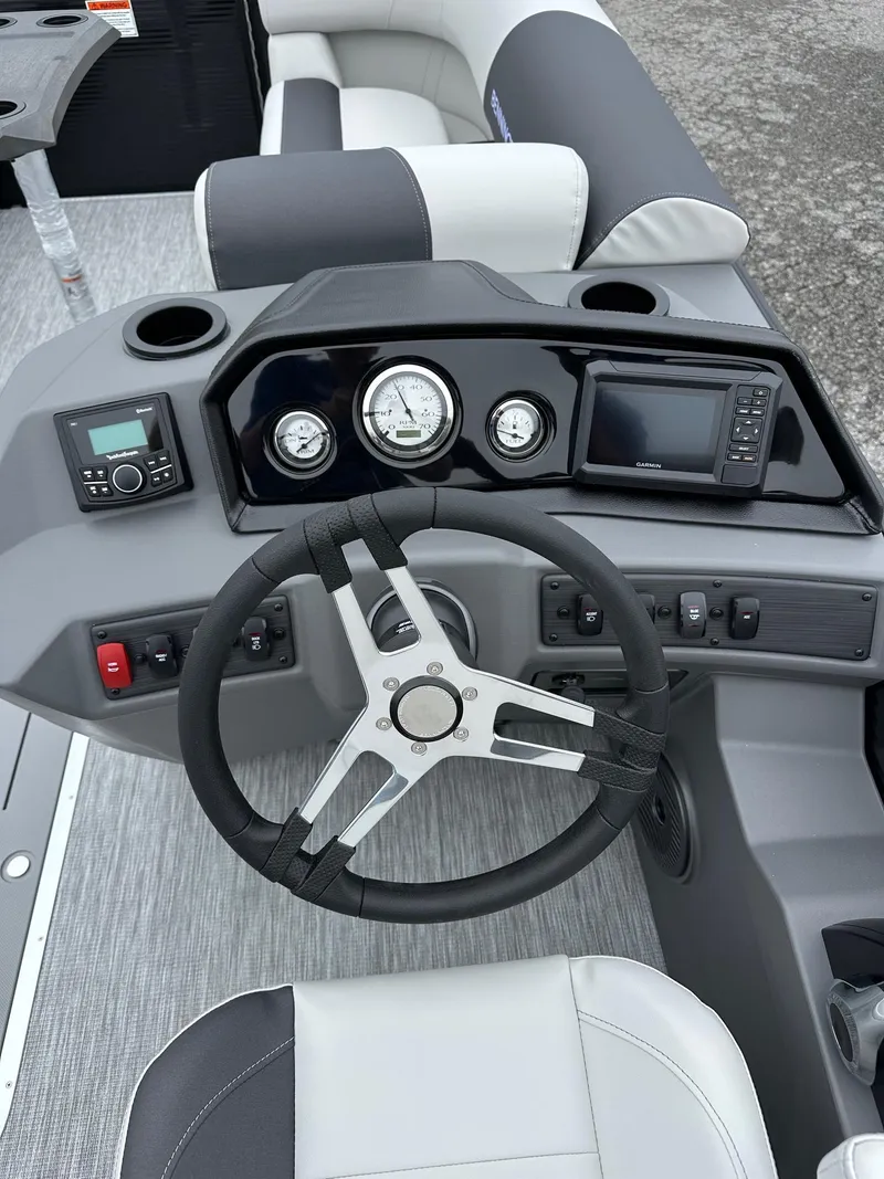 Slide: The Image of 2025 Bennington 22 SSR Tritoon dashboard with steering wheel and control panel. - 10