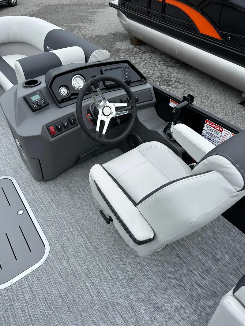 Slide: The Image of 2025 Bennington 22 SSR Quad Bench Tritoon interior with Yamaha F-150HP, featuring sleek helm design. - 13