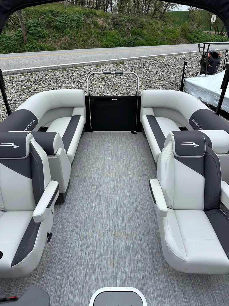 Slide: The Image of 2025 Bennington 22 SSR Quad Bench Tritoon interior with Yamaha F-150HP, featuring luxurious seating. - 14
