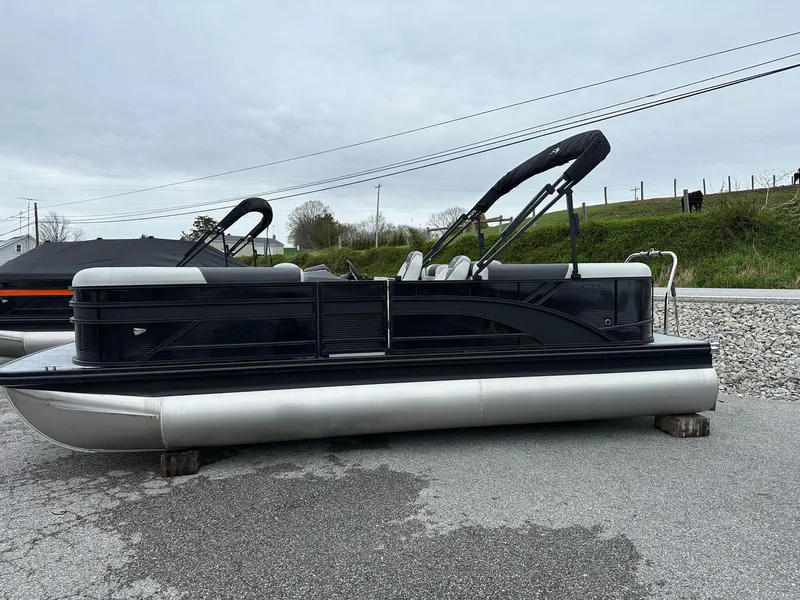 Slide: The Image of 2025 Bennington 22 SSR Quad Bench Tritoon with Yamaha F-150HP, displayed outdoors. - 21