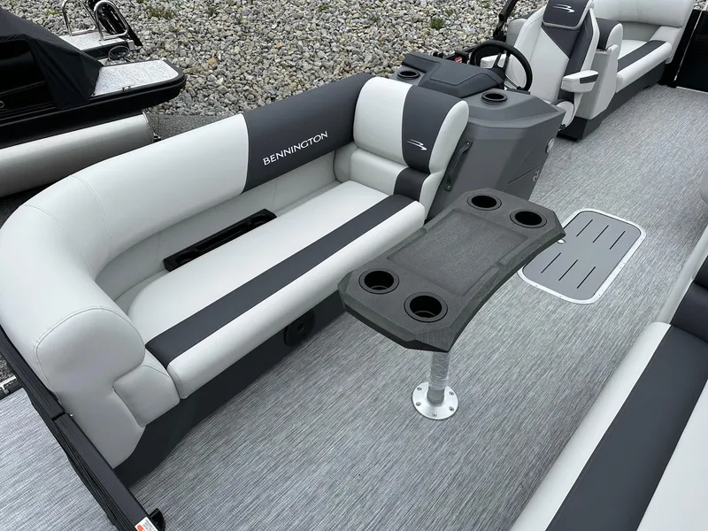 Slide: The Image of 2025 Bennington 22 SSR Quad Bench Tritoon interior with seating and table. - 23