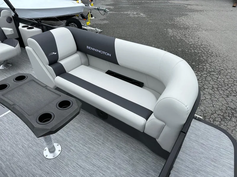 Slide: The Image of 2025 Bennington 22 SSR Quad Bench Tritoon interior with seating and table. - 24