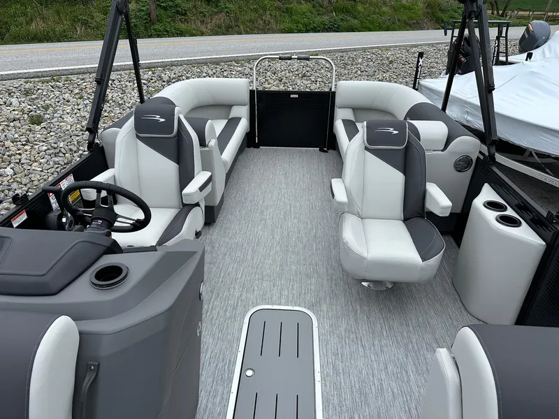 Slide: The Image of 2025 Bennington 22 SSR Quad Bench Tritoon interior with Yamaha F-150HP, featuring spacious seating. - 25
